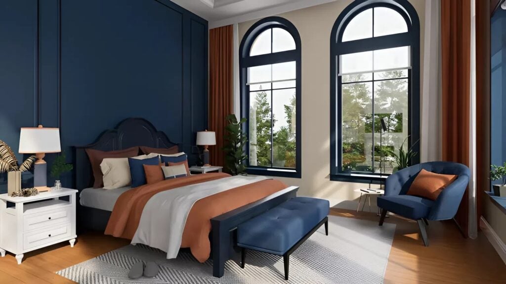 Freshly painted bedroom with navy blue power wall and orange accents by an interior painter in Belmont, CA