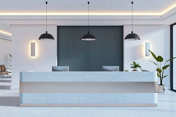Office reception with a charcoal accent wall and light gray finishes by a painting company in Atherton, CA.
